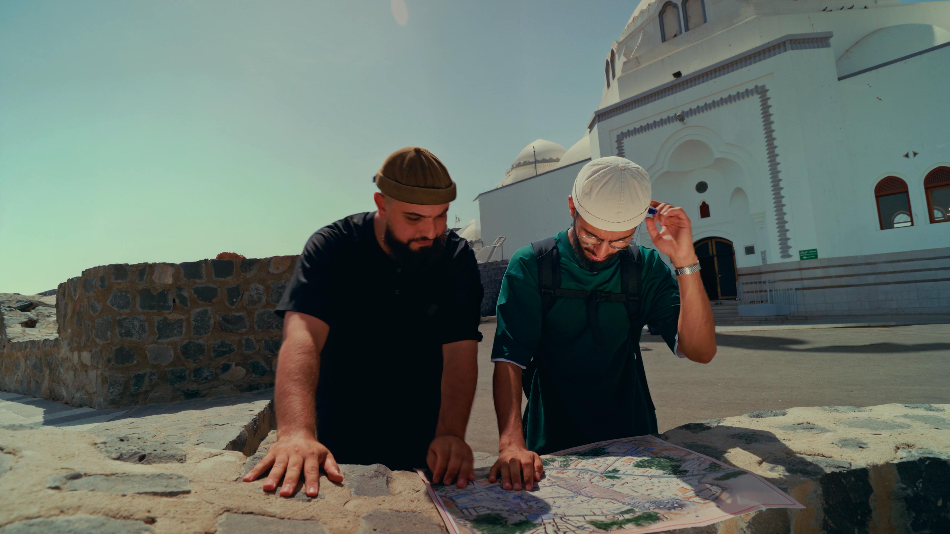 Reading a map on location in front of a historic mosque
